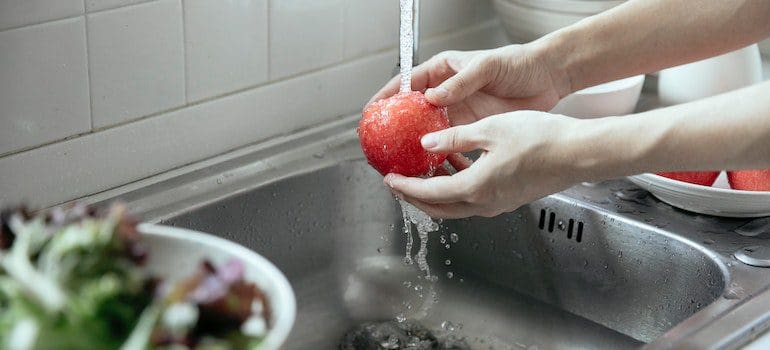 washing apple with clean water